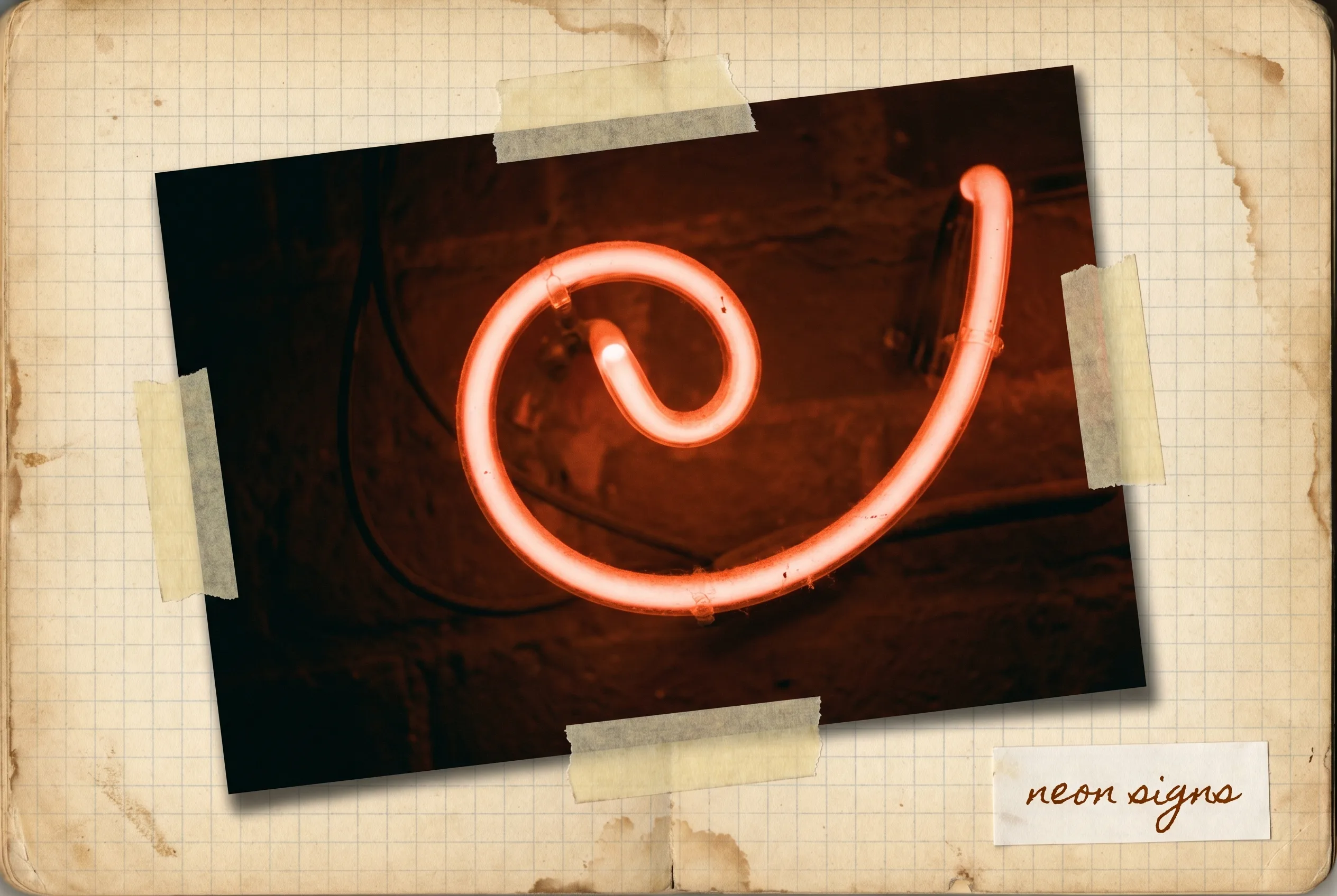 A curl of glowing red-orange neon sign tubing against a dark wall.