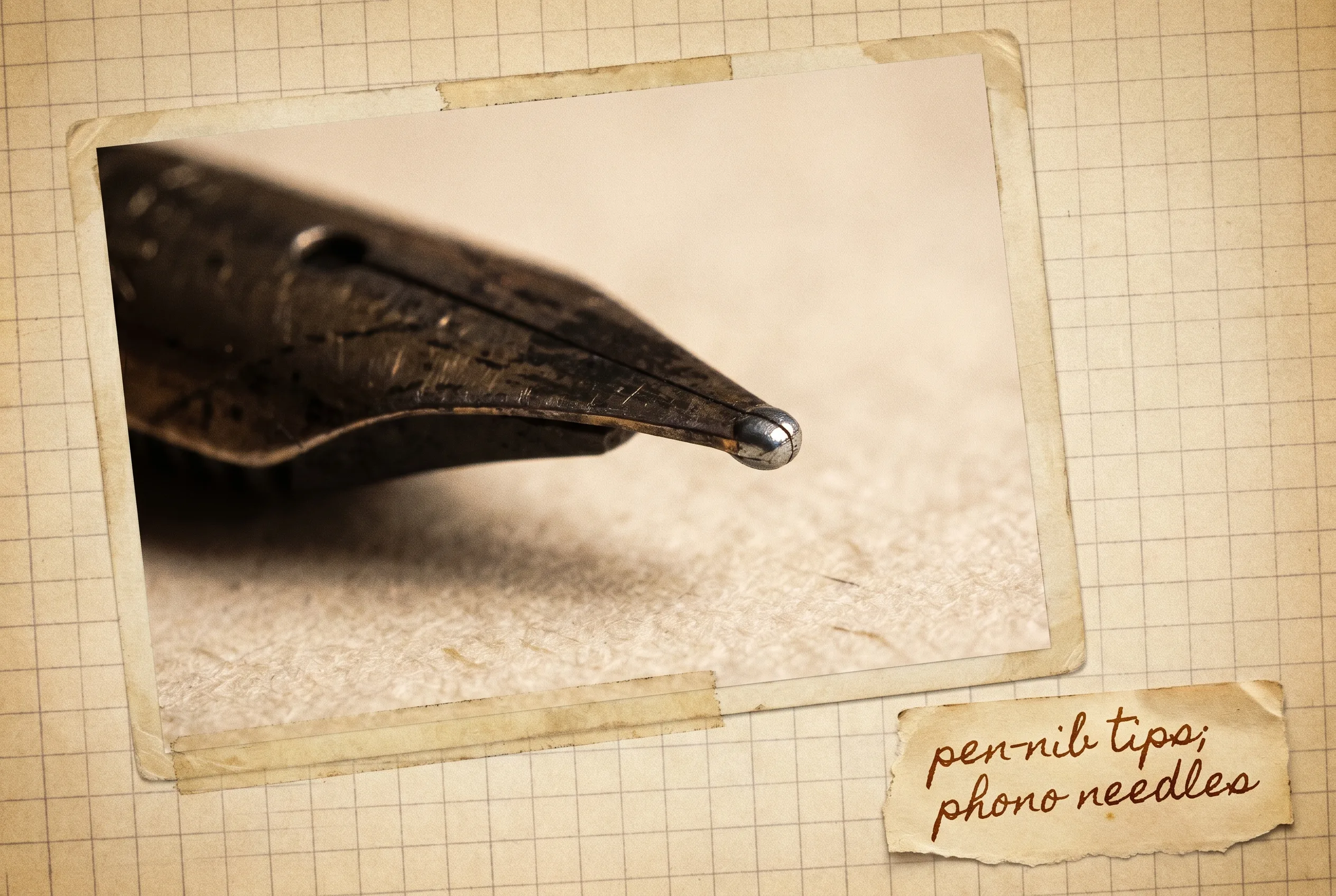 Macro of an antique fountain-pen nib with a tiny hard osmium-alloy pellet at the tip on paper.